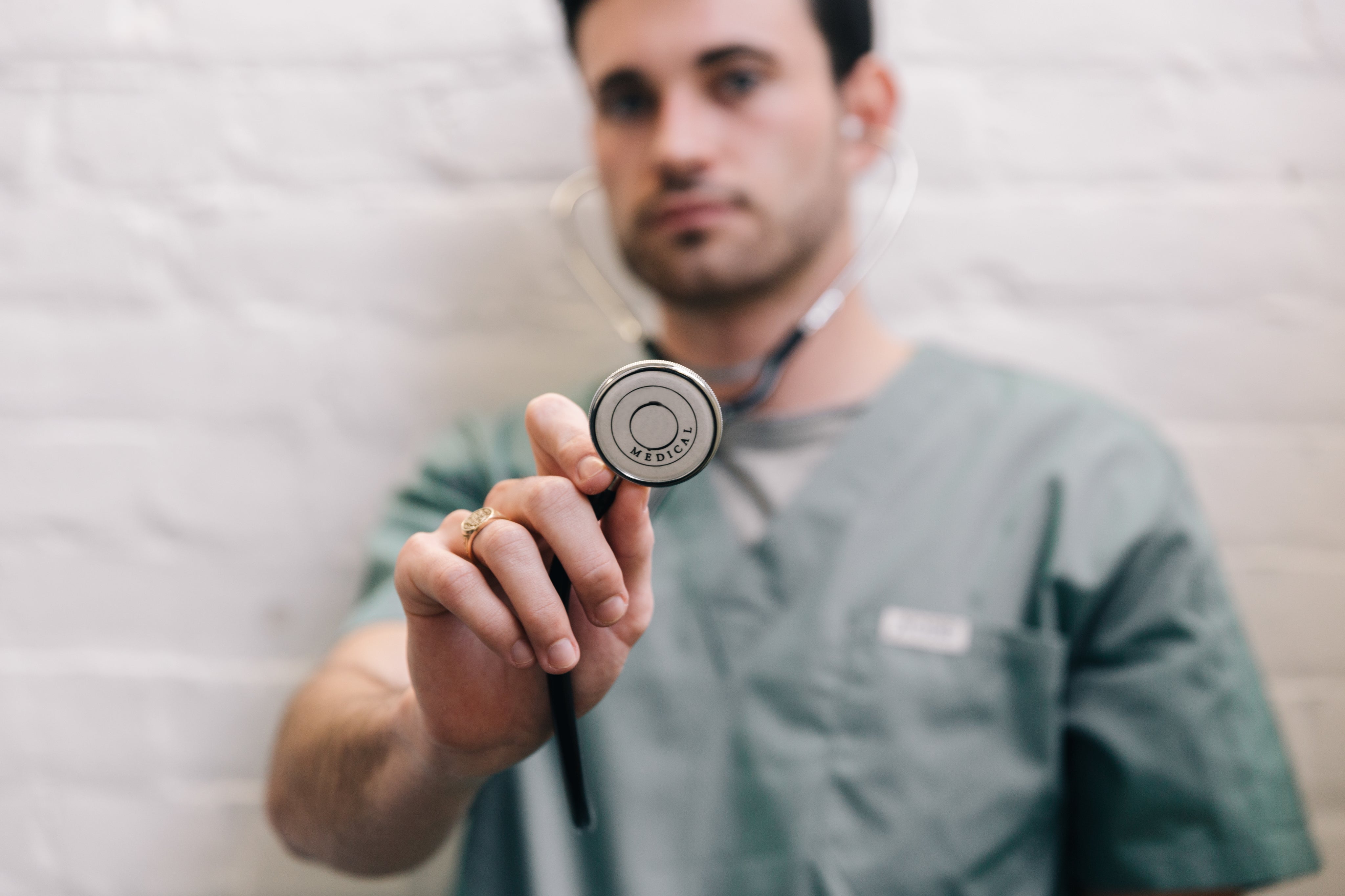 male-doctor-holding-out-stethoscope.jpg